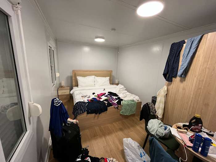 The hosts have called the shipping containers housing fans throughout the country “huts” in an attempt to fool visitors into believing they’re not ... sleeping in a shipping containers.